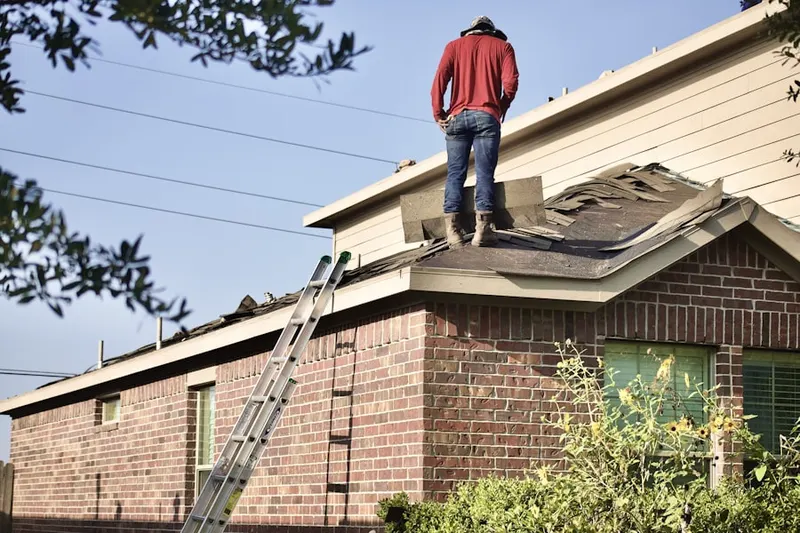 Professional roofer working on a residential roof in Forest Green Court